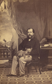 Man with Mustache and Muttonchops, seated with a dog on his lap, 1861-1864. Creator: Conway Weston Hart.
