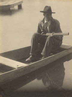 Black Man in Flat Boat, Holding Shotgun, 1929-1930. Creator: Doris Ulmann.