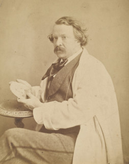 Self-portrait holding medallion commemorating his deceased mother, 1860-1861. Creator: Nadar.
