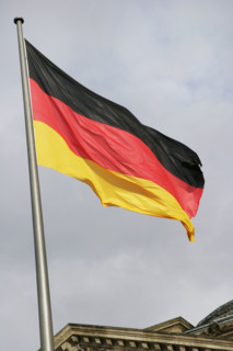 German flag next to the Reichstag building, Berlin, Germany, 2025.  Creator: LTL.