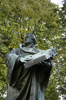 Bronze statue of Martin Luther next to the Marienkirche, (St Mary's Church), Berlin, Germany, 2025.  Creator: LTL.