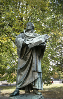 Bronze statue of Martin Luther next to the Marienkirche, (St Mary's Church), Berlin, Germany, 2025.  Creator: LTL.