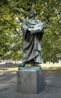 Bronze statue of Martin Luther next to the Marienkirche, (St Mary's Church), Berlin, Germany, 2025.  Creator: LTL.