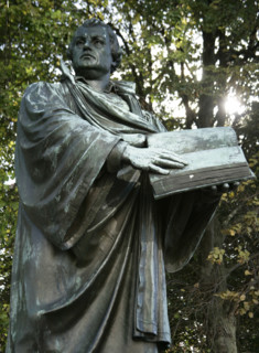 Bronze statue of Martin Luther next to the Marienkirche, (St Mary's Church), Berlin, Germany, 2025. Creator: LTL.