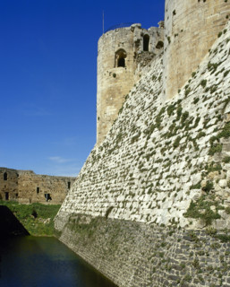 View of walls and moat, Krak des Chevaliers, Talkalakh District, Syria Arab Republic, 1999.  Creator: LTL.