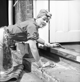 Charlady scrubbing steps, c1955. Creator: Arthur Charles Kirby Ware.