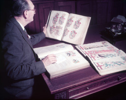 Mr. Mitchell (Herald Painter) in Records Room, College of Arms, London, c1953. Creator: Arthur Charles Kirby Ware.