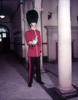 Guards officer in full dress uniform with bearskin on and sword drawn, London,  Creator: Arthur Charles Kirby Ware.