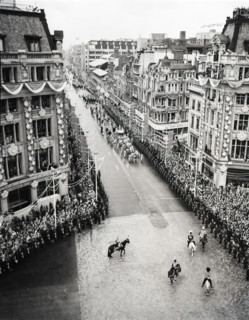 Crowds watching the coronation procession of Queen Elizabeth II, Oxford Circus, London, 2 June 1953. Creator: Arthur Charles Kirby Ware.