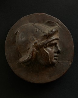 Cast of head of full-faced, young Roman soldier in helmet. Creator: Unknown.