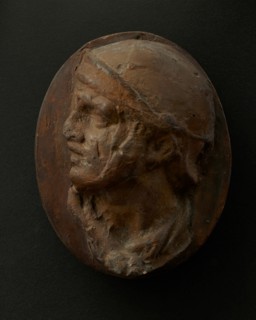 Cast of the head of Roman soldier in helmet and scarf with raised right arm. Creator: Unknown.