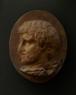 Cast of head of bearded Roman official wearing cloak. Creator: Unknown.