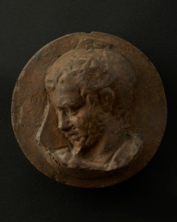 Cast of head of oarsman looking down, with vertical edge of building behind. Creator: Unknown.