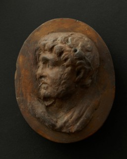 Cast of head of lightly-bearded man wearing wreath (?) and with mouth open. Creator: Unknown.