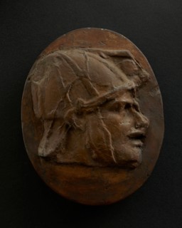 Cast of head of Eastern archer with helmet. Creator: Unknown.