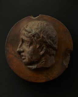 Cast of clean-shaven Roman man wearing a wreath. Creator: Unknown.