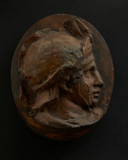 Cast of head of young auxiliary wearing a helmet. Creator: Unknown.