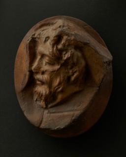 Cast of severed Dacian head held by a right hand.  Creator: Unknown.