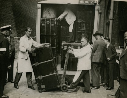 Staff from Bishop & Sons Depositories Ltd unload a case at Burlington House, 1935. Creator: Topical Press Agency.