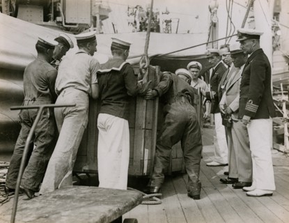 Unloading a case from H.M.S. Suffolk at Portsmouth, July 1935. Creator: Topical Press Agency.