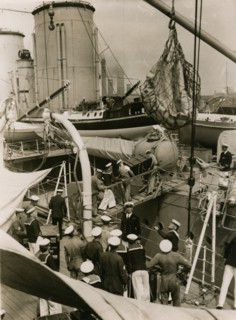 Transfering cases from H.M.S. Suffolk to H.M.S. Hood at Portsmouth, July 1935. Creator: Topical Press Agency.