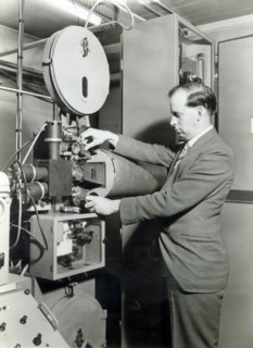 Man operating film projector, c1955. Creator: Arthur Charles Kirby Ware.