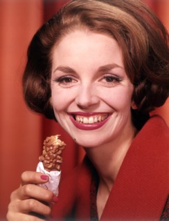 Model eating chocolate bar, c1955. Creator: Arthur Charles Kirby Ware.