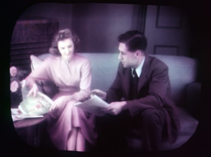 Couple sitting on sofa within TV screen, c1955. Creator: Arthur Charles Kirby Ware.