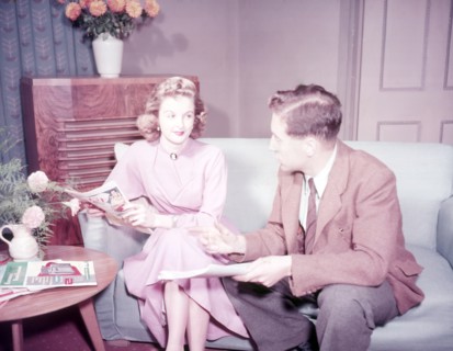 Couple sitting on sofa, c1955. Creator: Arthur Charles Kirby Ware.