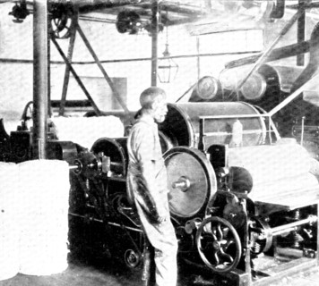 Opening, or loosening, the cotton: removing impurities by scutching..., 1909.  Creator: Unknown.