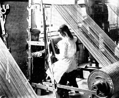 Preparing for the weaving: drawing-in, 1909.  Creator: Unknown.