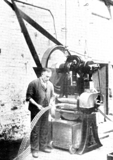 Cutting the familiar crosses: a metal-stamping machine, used in the making of rubber heels..., 1909. Creator: Unknown.