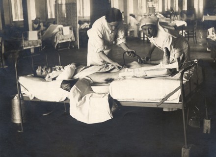 Dans un hôpital militaire à l'arrière du front, un médecin avec l'aide d'une infirmière, donnent