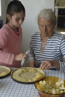 Girl making pastry with her grandmother