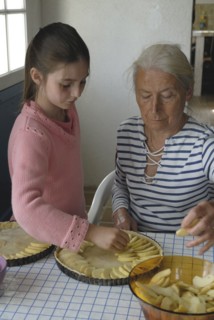 Girl making pastry with her grandmother