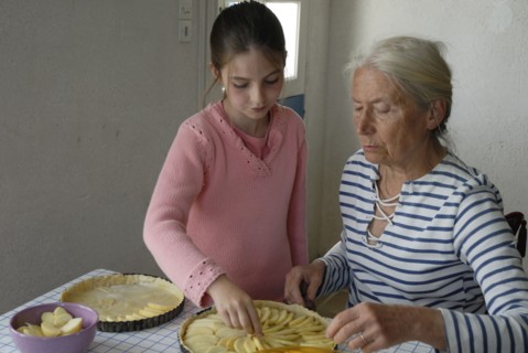 Girl making pastry with her grandmother