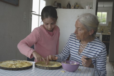 Girl making pastry with her grandmother