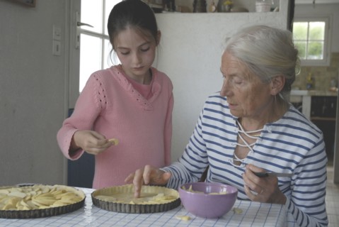Girl making pastry with her grandmother