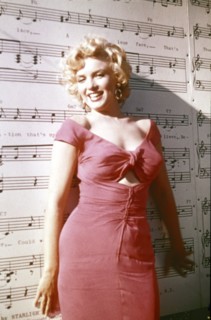 MARILYN MONROE, portrait in front of music wall