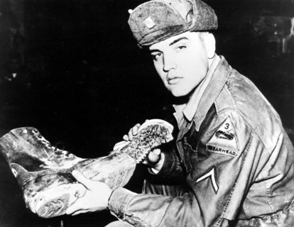 Elvis PRESLEY as a soldier cleaning boots, 1958
