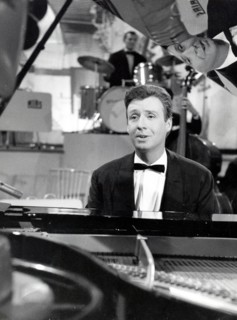 Peter ALEXANDER singing on the piano