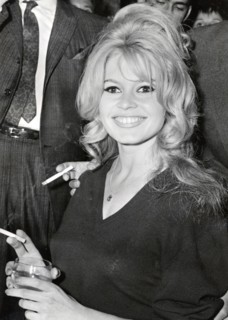 Brigitte BARDOT, portrait with cigarette and drinking glass