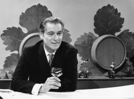 Rudolf PRACK at a wine stand, undated