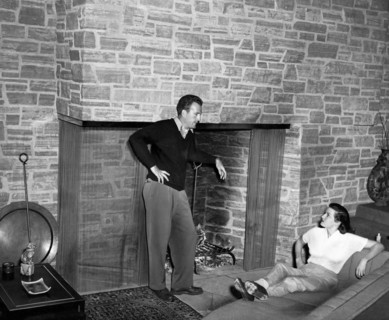 Bob WATERFIELD and Jane RUSSELL in their living room, undated
