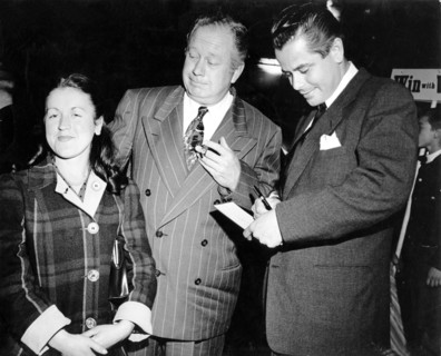 Glenn FORD gives an autograph to a fan, next to SZ SAKALL