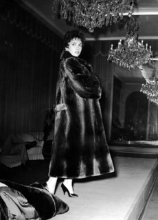 Gina LOLLOBRIGIDA trying on a fur coat, 1956