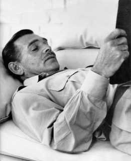 Clark GABLE reading on his farm