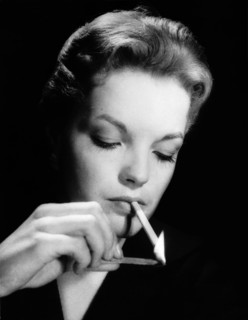 Romy SCHNEIDER, portrait while lighting a cigarette