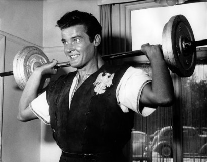 Roger MOORE with dumbbell while filming, 1958