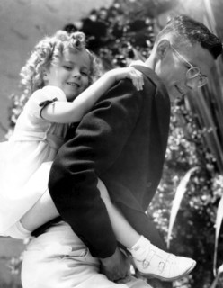 Shirley TEMPLE on the back of her brother Jack Temple, 1934